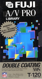 A vintage Fuji A/V PRO Library VHS tape cover features a colorful abstract design with overlapping rectangles in blue, green, and yellow tones, set against a black background. The text highlights the product's suitability for high-fidelity stereo recording with double coating technology.