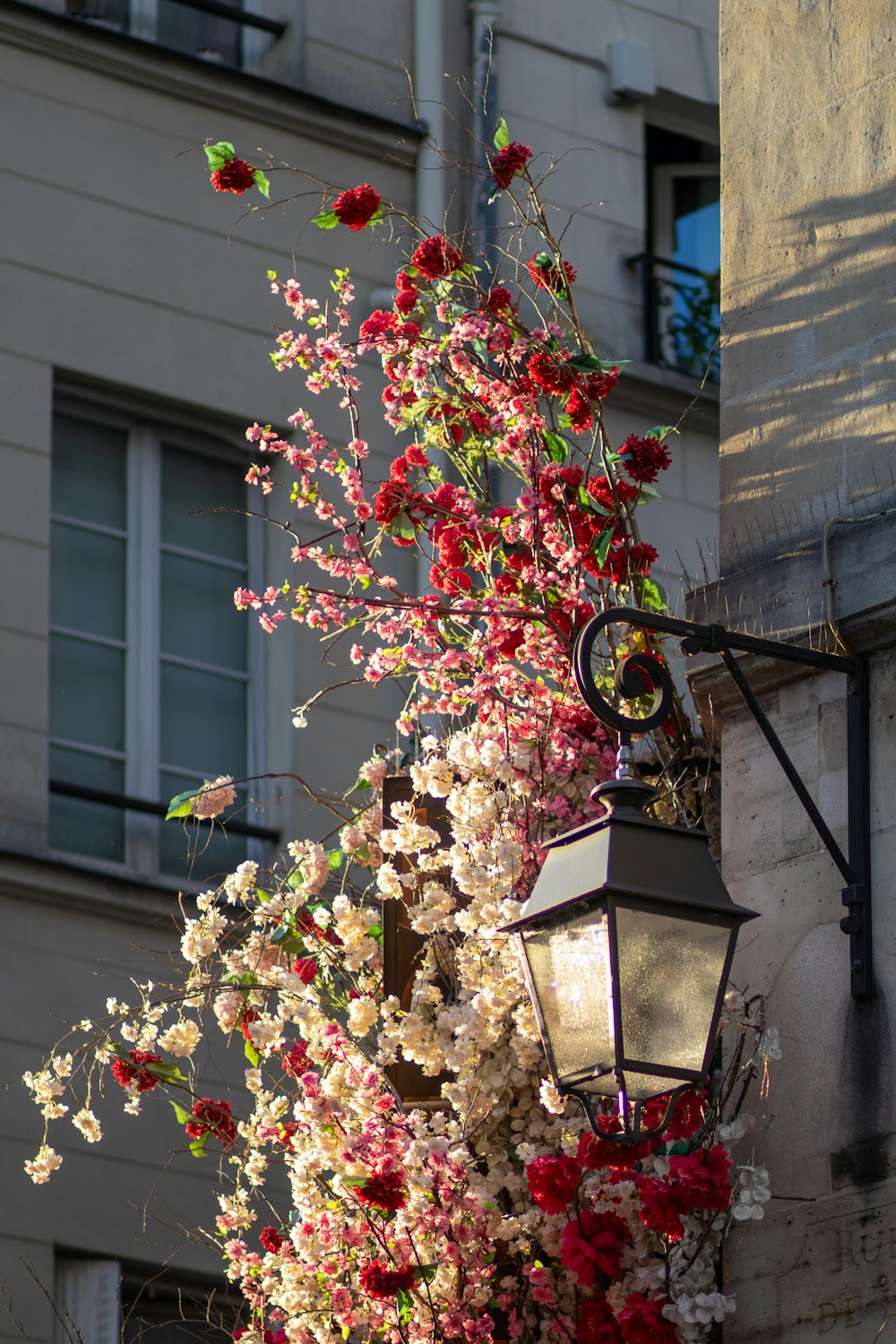 a lamp post with a bunch of flowers on it