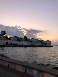 A serene Asian coastal village at sunset, symbolizing peaceful retirement.