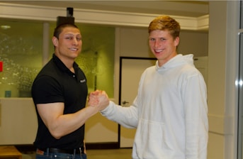 A happy homeowner shaking hands with a real estate investor
