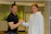 Happy client shaking hands with a friendly consultant in a bright conference room.