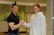 Smiling customer shaking hands with a heating technician after service completion.