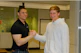 Image of a professional shaking hands with a supplier inside a modern warehouse.