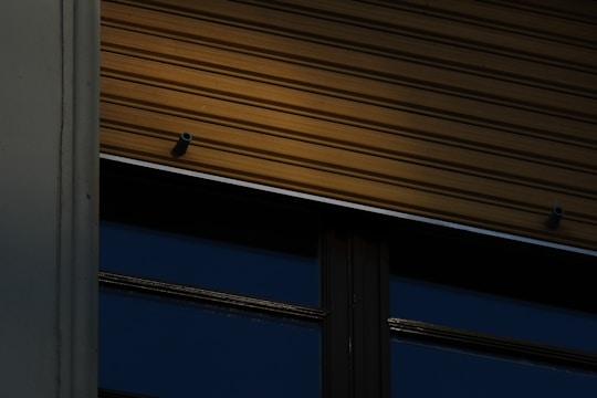 Close-up of durable aluminum blinds with colorful finishes on a commercial building.