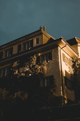 A serene European villa facade with subtle golden lighting.