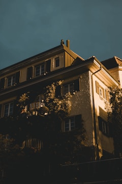 A serene European villa facade with subtle golden lighting.