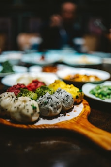 A colorful spread of different lumpia varieties served on rustic wooden platters.