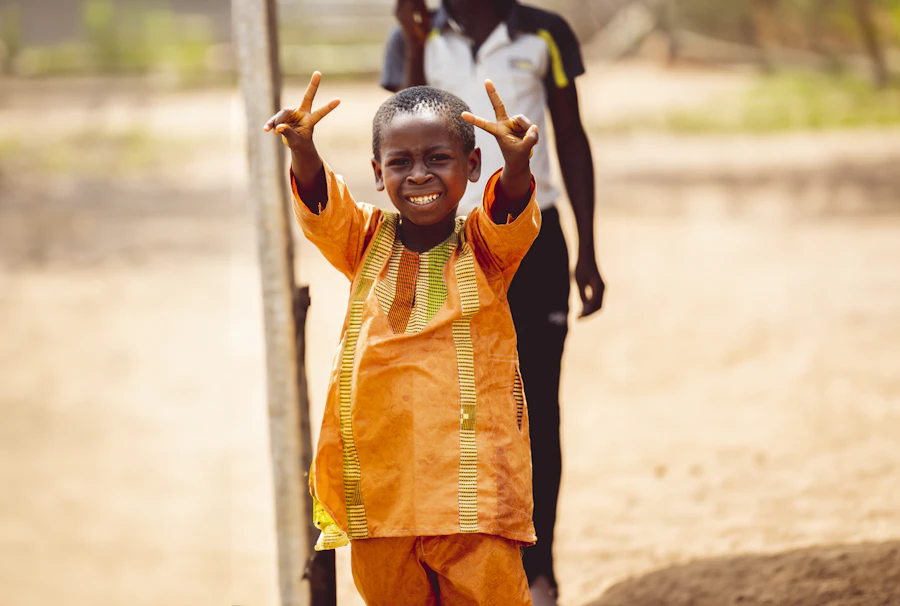 A boy from Charity Home Foundation smiling outdoors