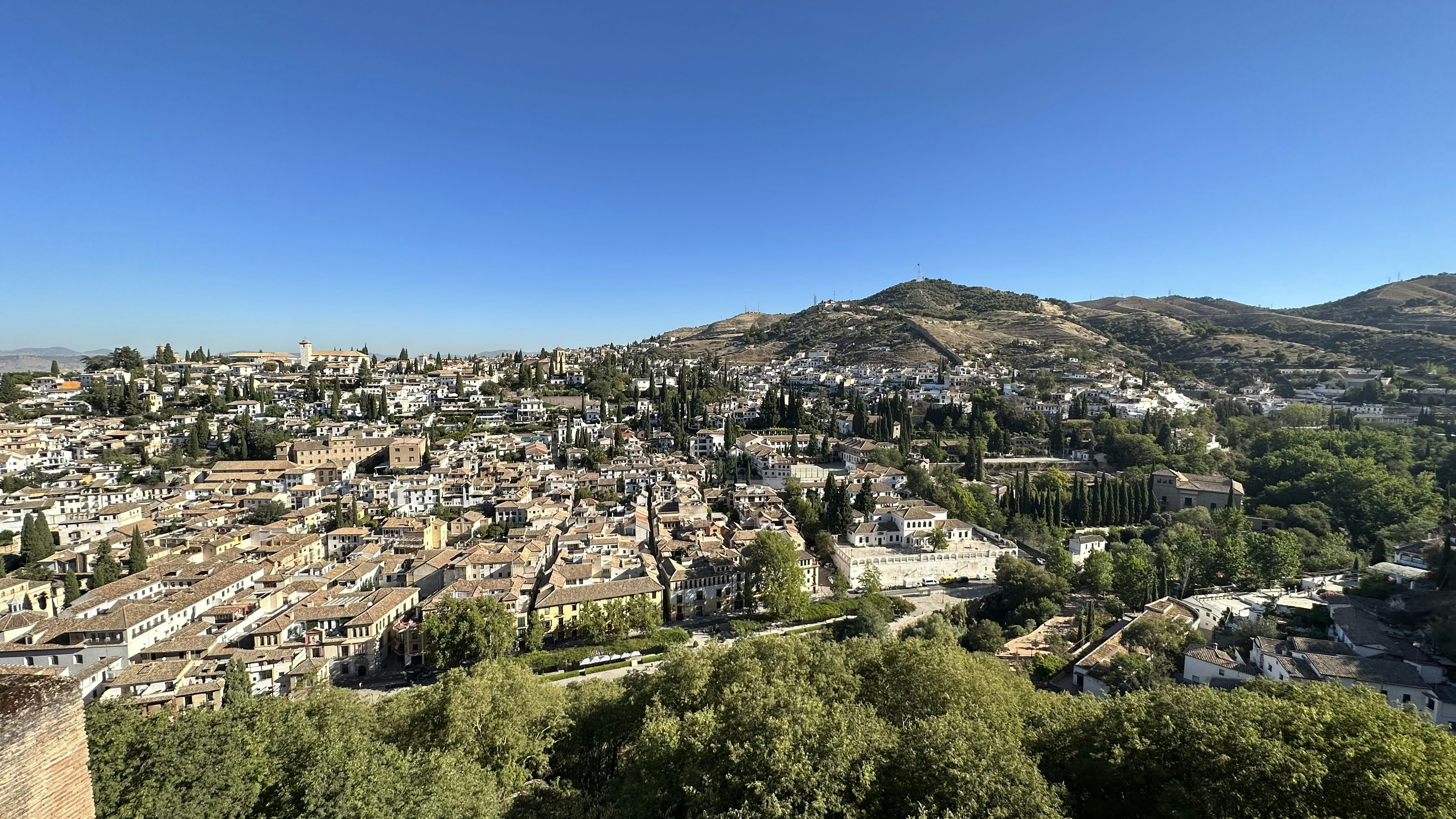 a view of a city with mountains in the background
