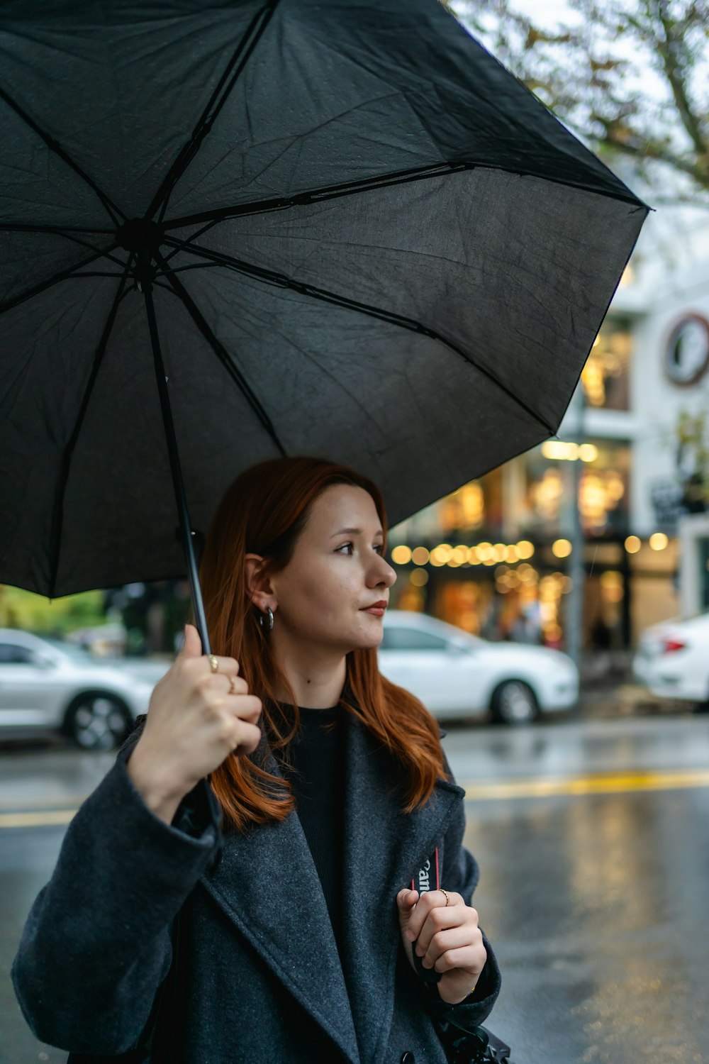 a woman holding an umbrella in the rain