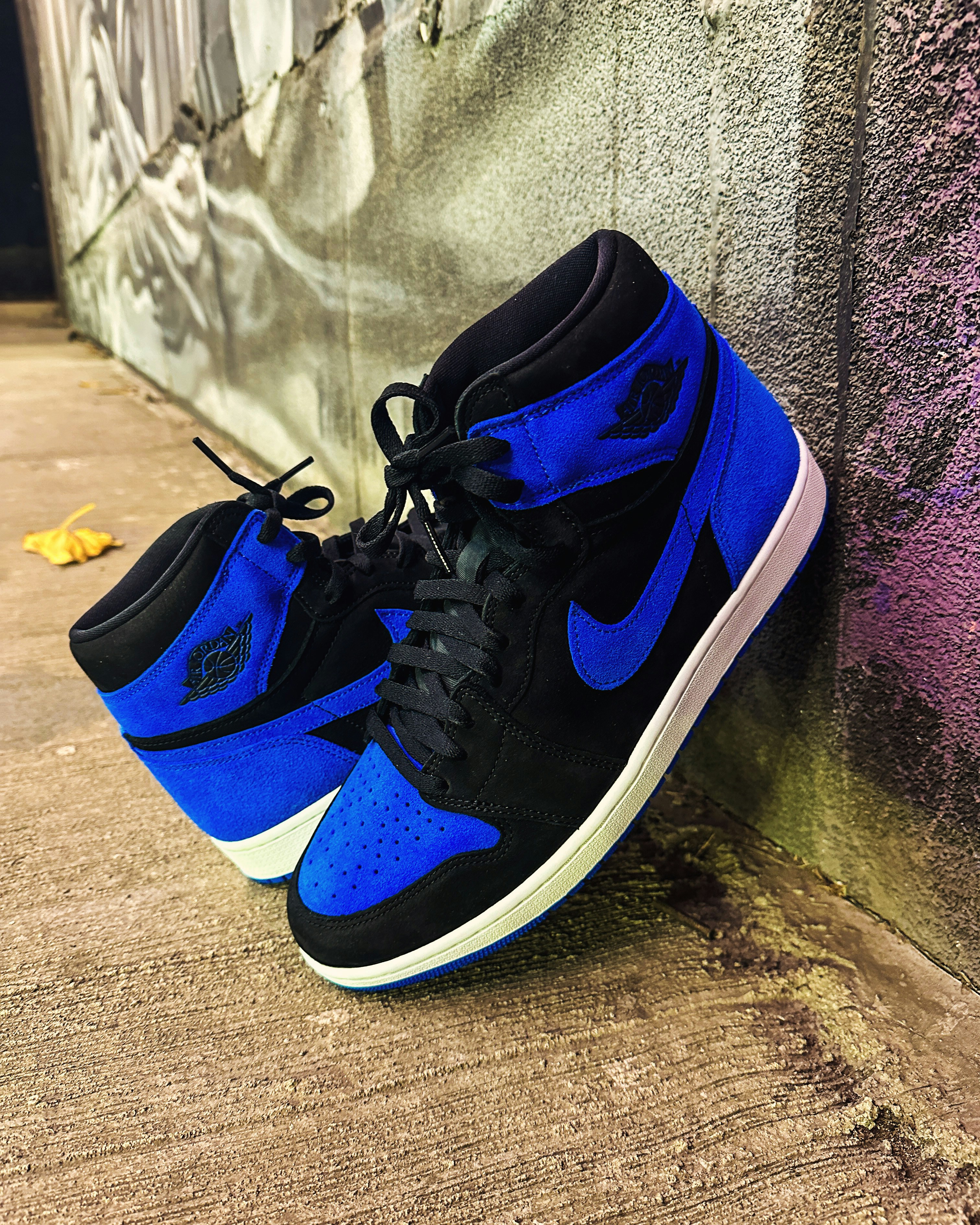 A pair of blue and black sneakers on a sidewalk photo – Free Blue Image ...