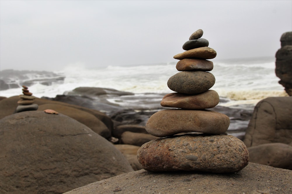 a stack of rocks sitting on top of a beach