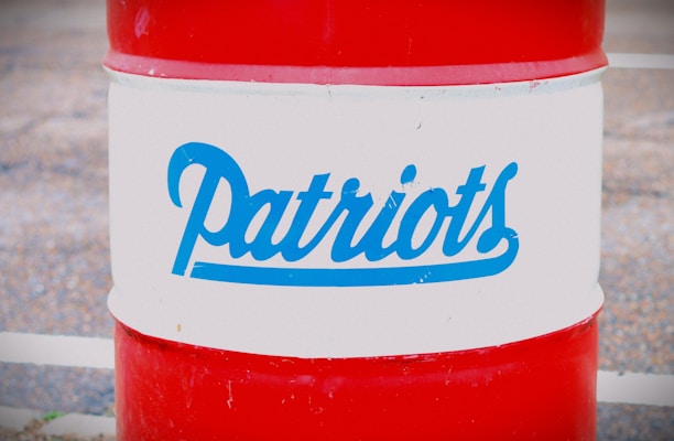 A red and white barrel with the word 'Patriots' written in blue script across the middle section.