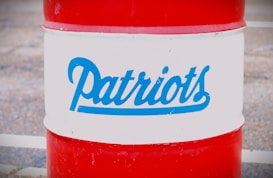 A red and white barrel with the word 'Patriots' written in blue script across the middle section.
