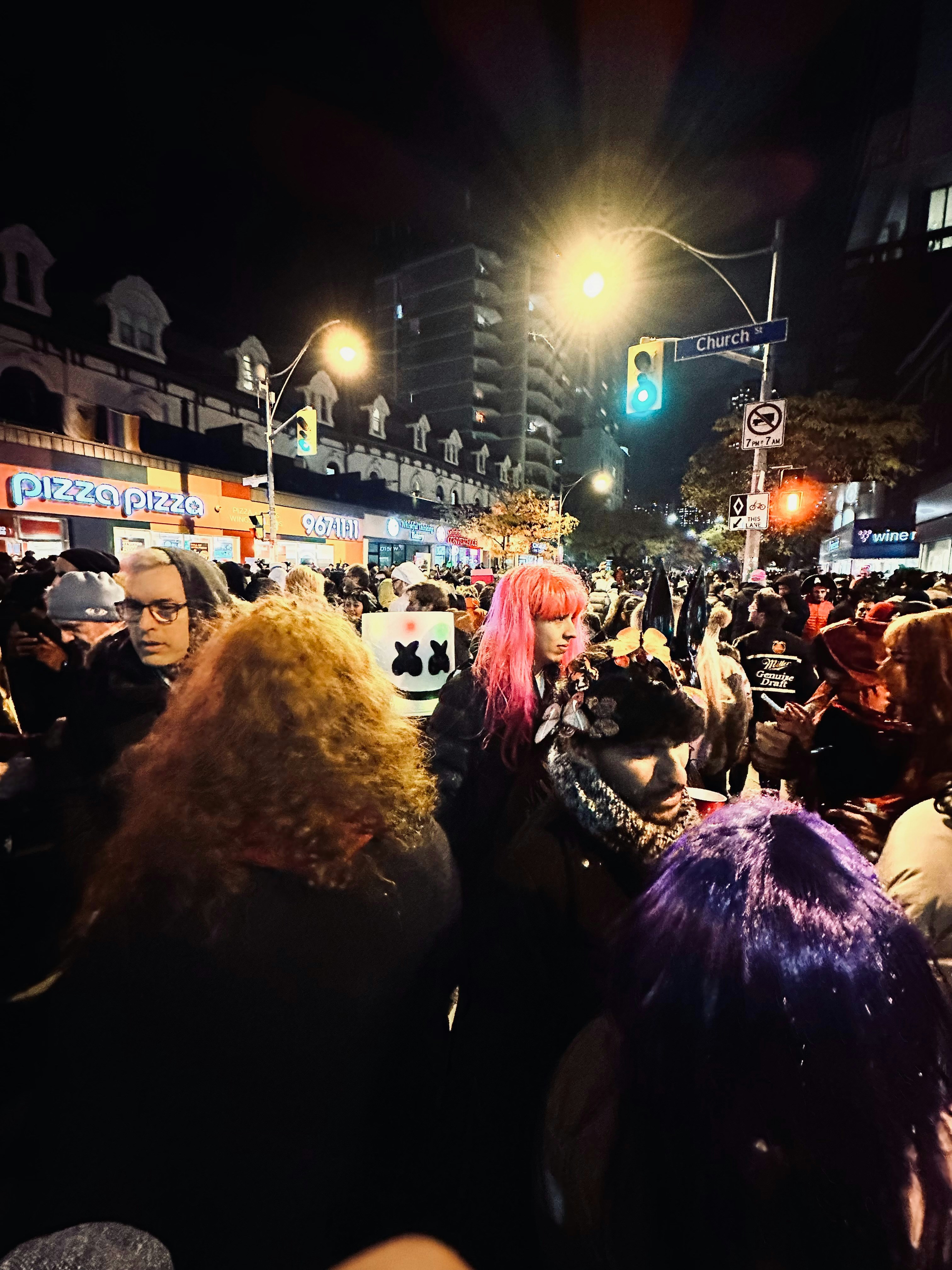 West Hollywood nightlife scene on Santa Monica Boulevard with colorful bar signs and diverse crowd