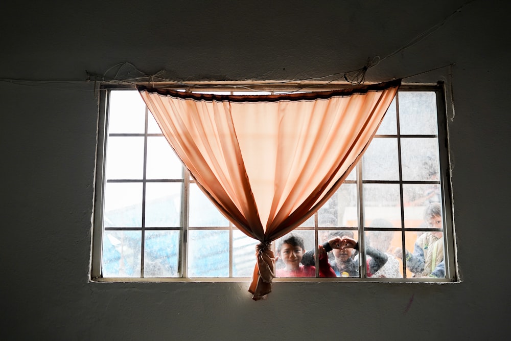 a group of people are looking out of a window