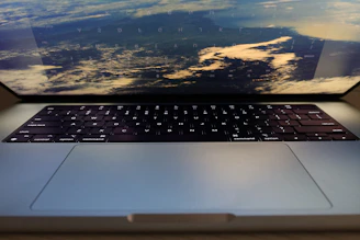 Hands typing on a Starlink laptop keyboard with a scenic window view in the background.