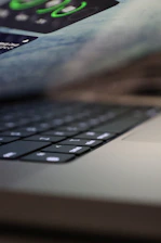 Close-up of hands typing on a sleek keyboard with privacy-focused icons subtly visible on the screen.