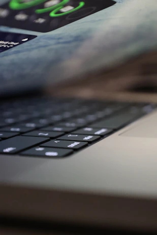 Close-up of hands typing on a sleek keyboard with privacy-focused icons subtly visible on the screen.