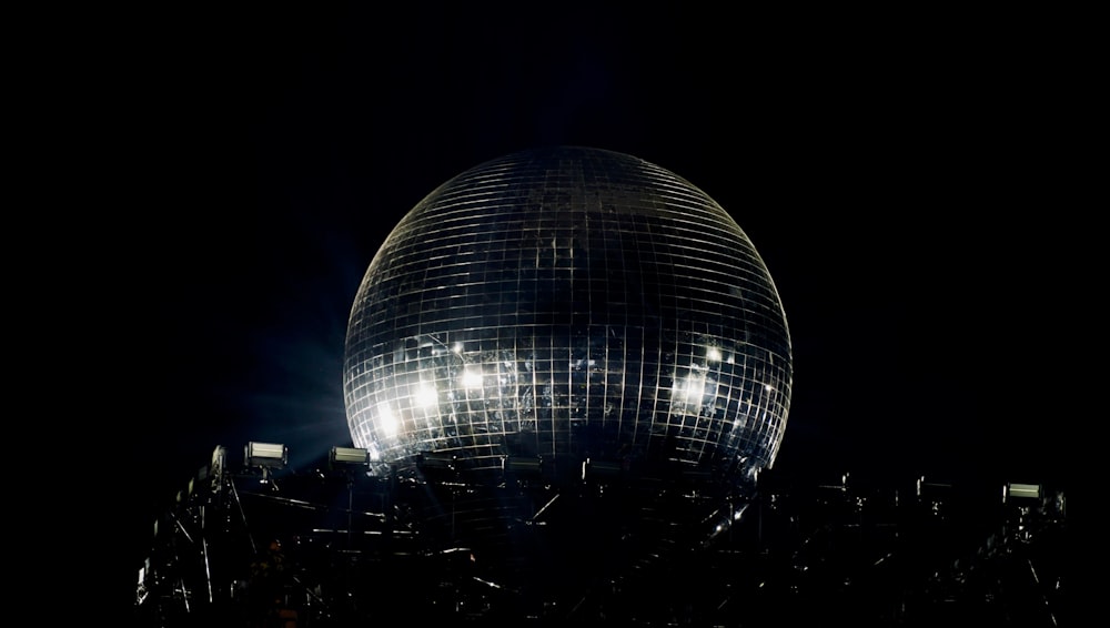 a large disco ball sitting in the middle of a city