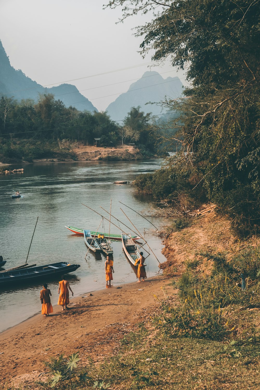 a group of people standing next to a body of water