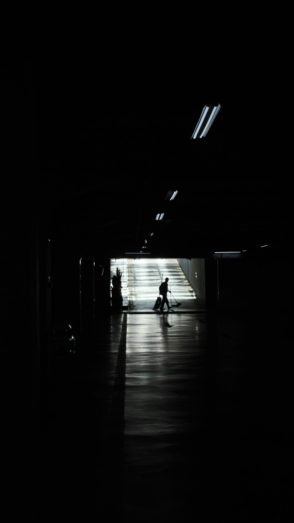 a person riding a motorcycle through a dark tunnel