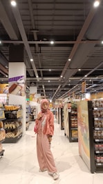 A friendly customer browsing groceries on an easy-to-use online store interface with Islamic and gold color accents.