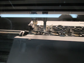 Close-up of a professional embroidery machine in action with colorful threads