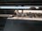 A close-up of a textile machine in operation, showcasing intricate details and precision.