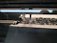 Close-up of a high-speed OLH embroidery machine stitching intricate patterns on fabric.
