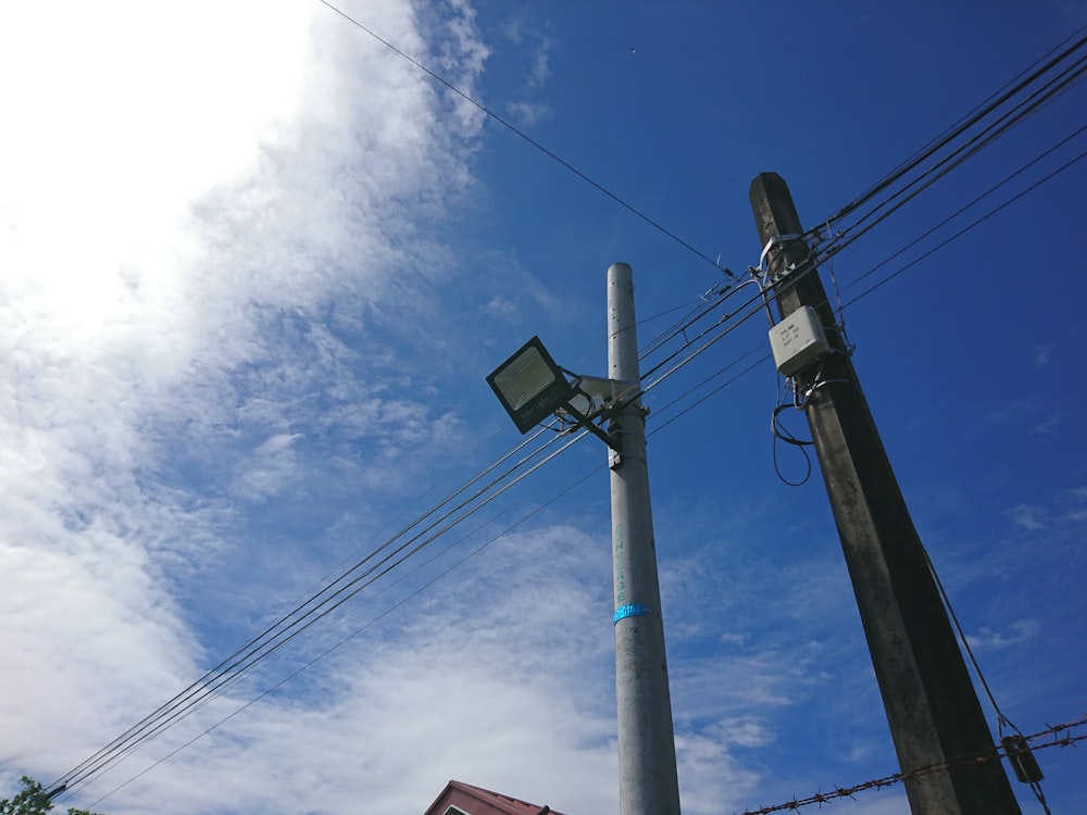 a street light sitting next to a tall pole