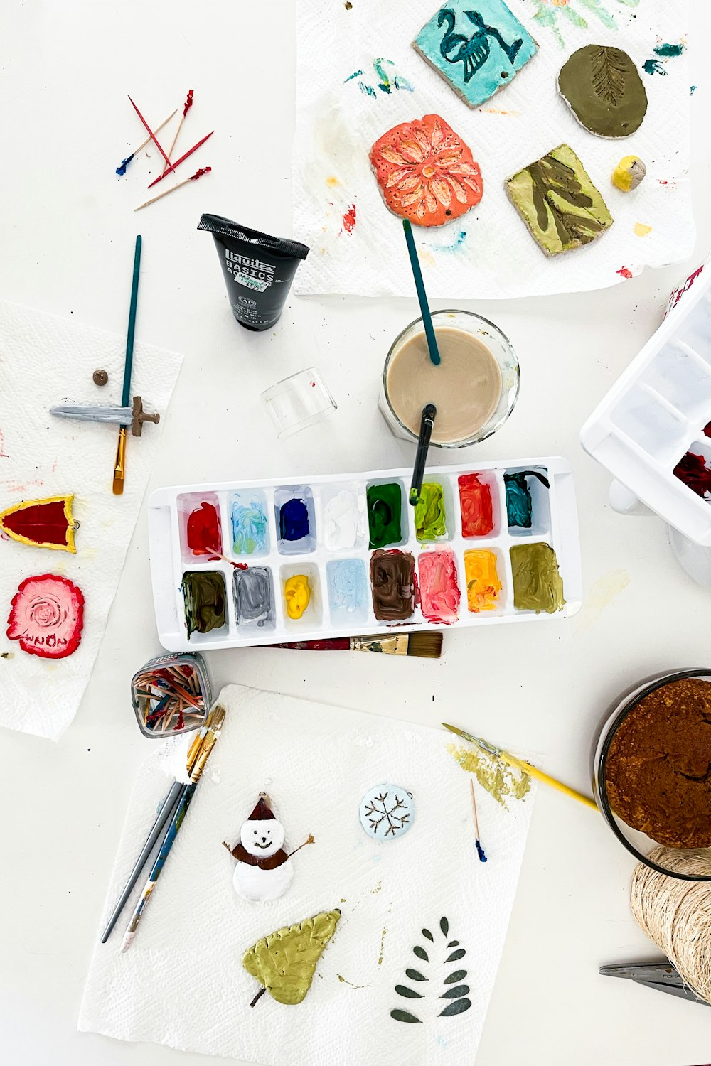 a table topped with lots of different types of art supplies