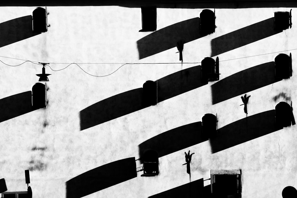 a black and white photo of shadows on a wall