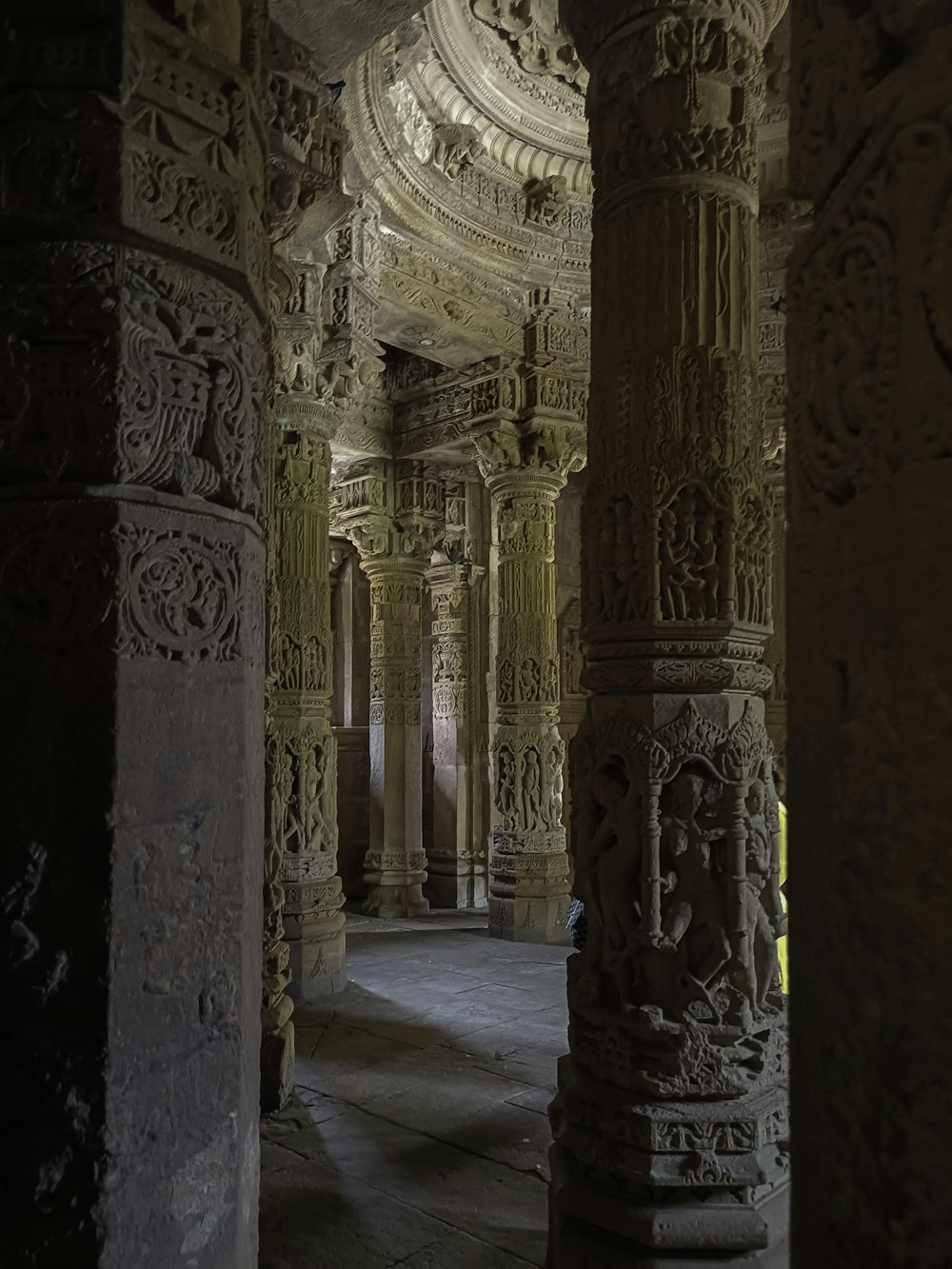 the interior of a building with columns and carvings
