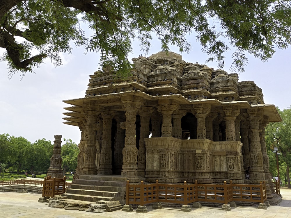 a large stone structure sitting under a tree