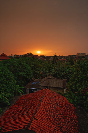 Sunset view over the lush green landscape surrounding Aravium Living resort.
