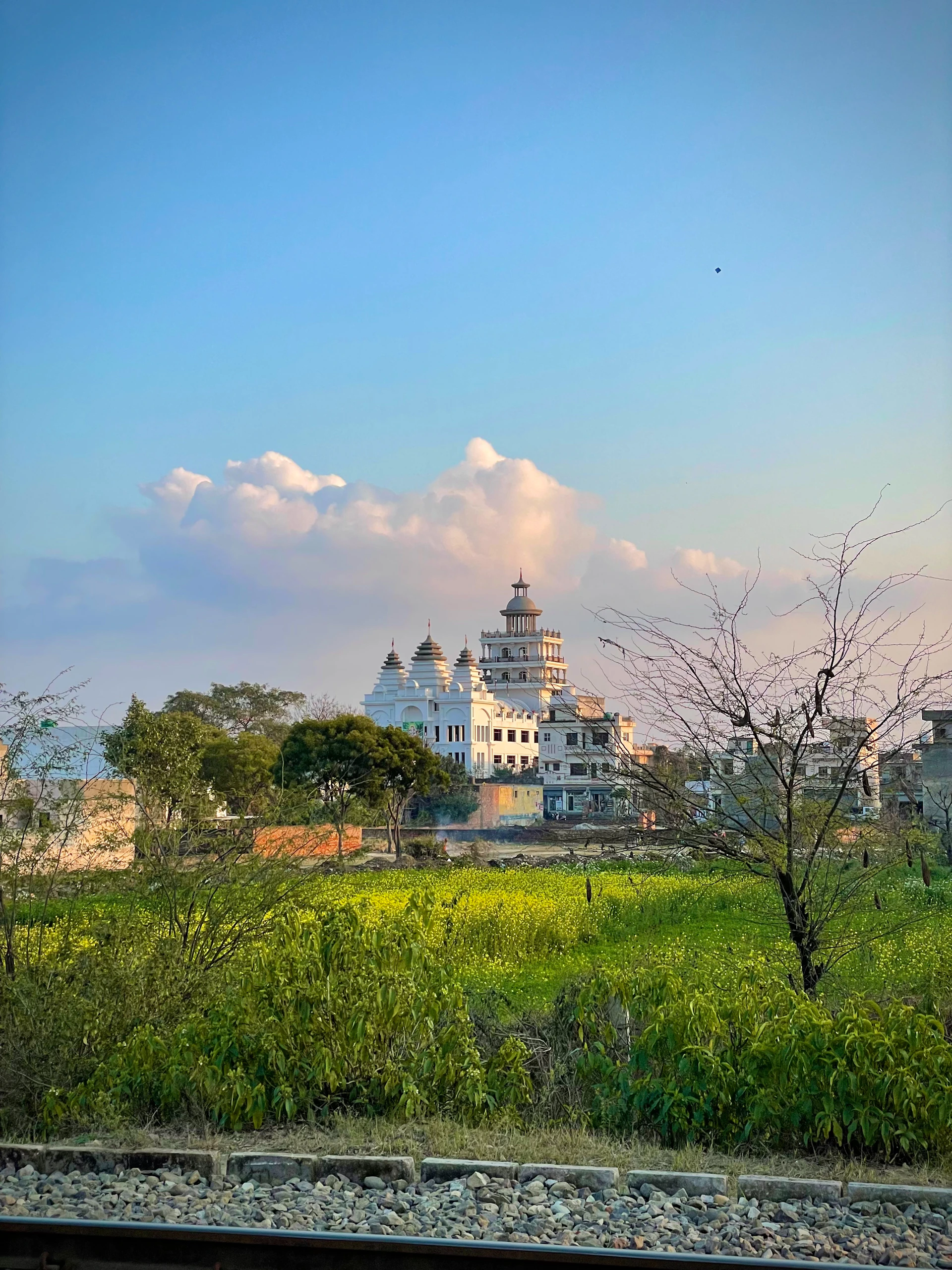 woman wearing yellow long-sleeved dress under white clouds and blue sky during daytime