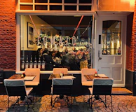 A cheerful restaurant owner sharing a laugh with the Pomodoro marketing team during a strategy meeting.