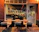 Photo of a happy restaurant owner discussing marketing plans with the Pomodoro team in a cozy Scandinavian-style cafe.