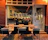 Photo of a happy restaurant owner discussing marketing plans with the Pomodoro team in a cozy Scandinavian-style cafe.