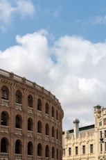 a large brown building with a clock on it's side