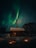 A cozy cabin under a vibrant aurora borealis sky in the Arctic wilderness.