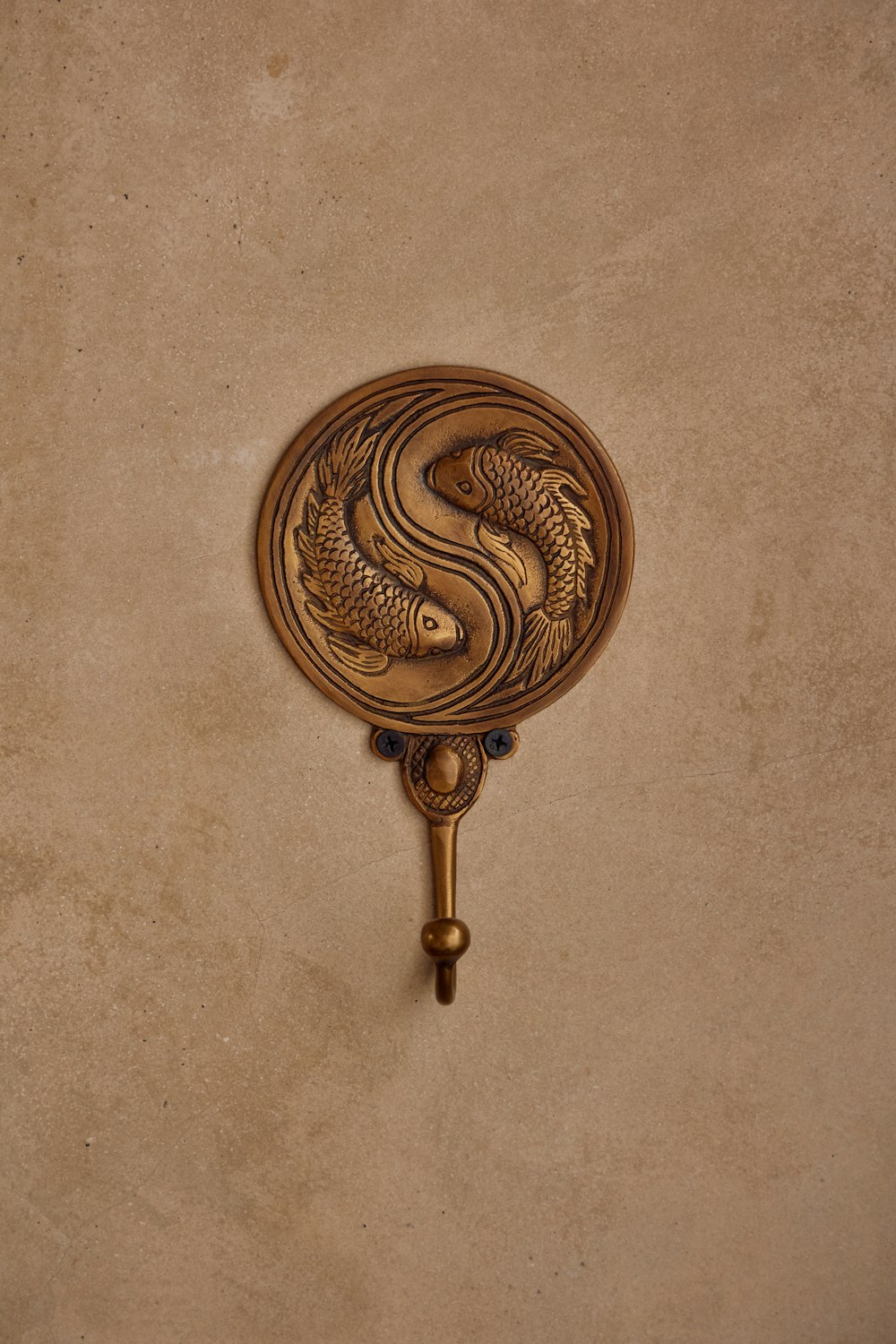 a wall mounted hook with a fish design on it