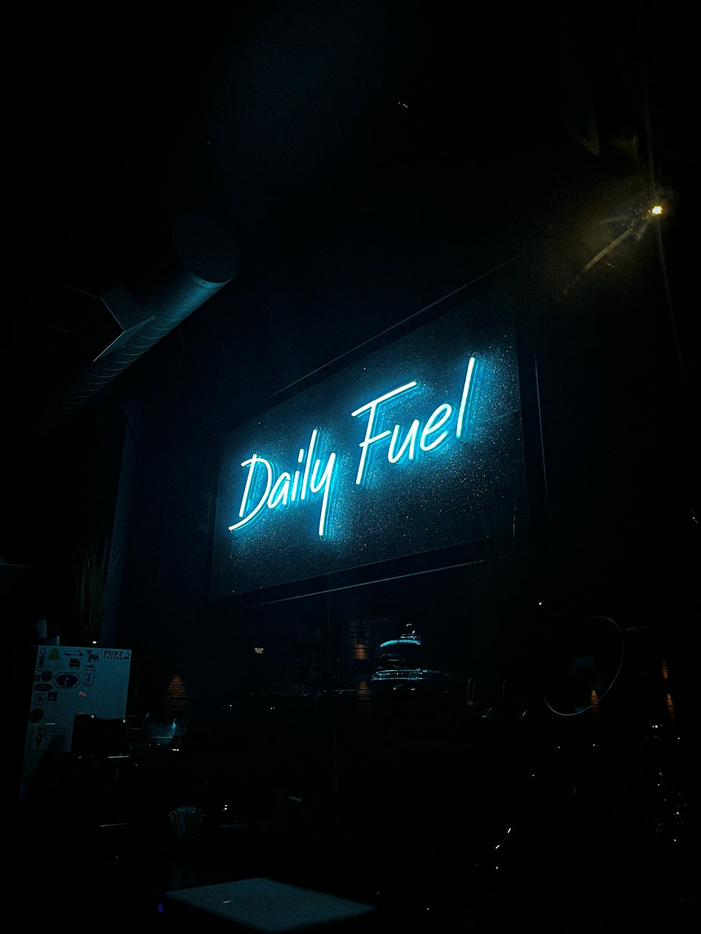 a neon sign is lit up in the dark