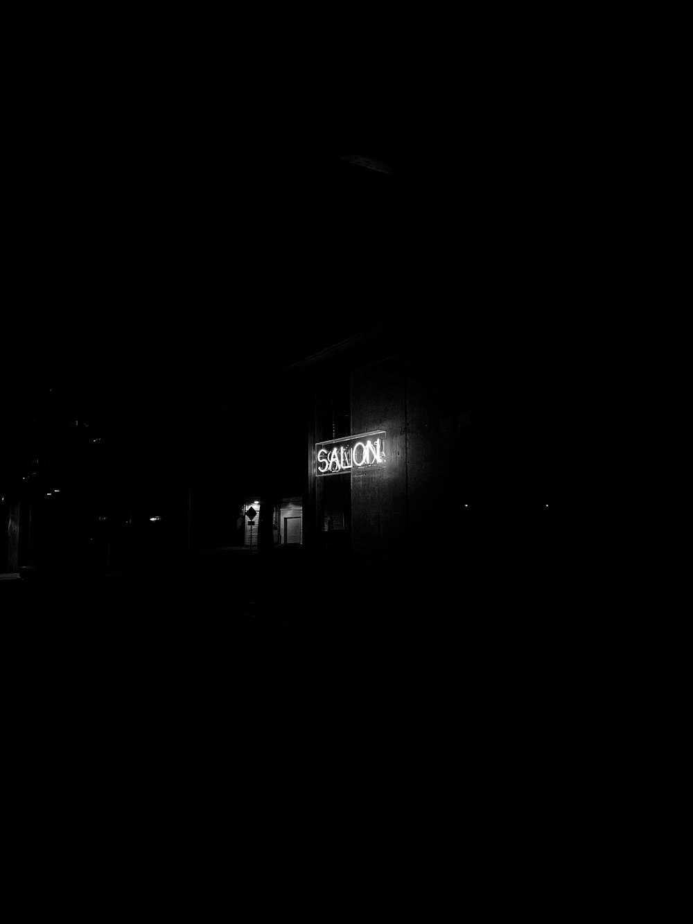 a black and white photo of a building at night