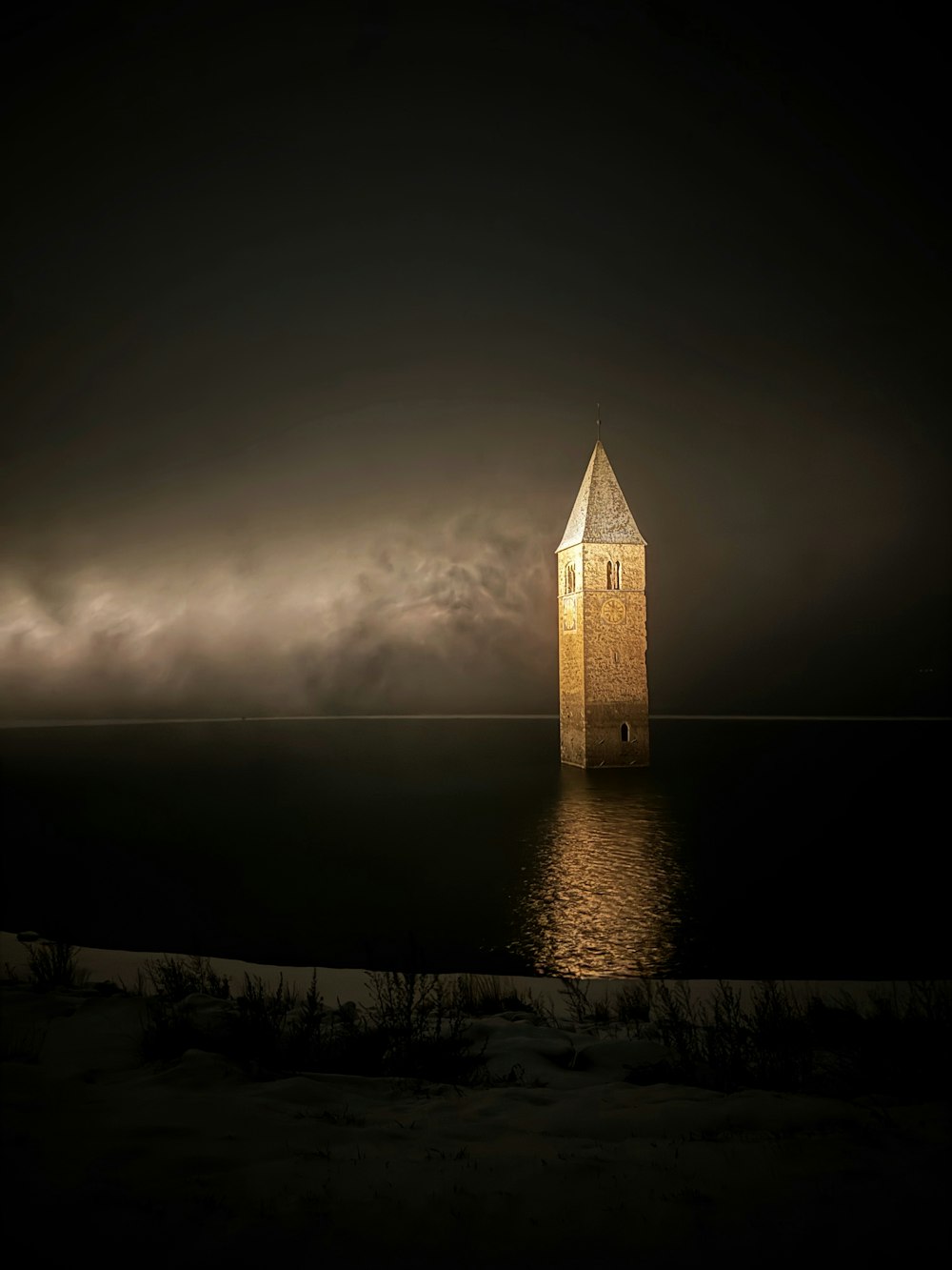 a clock tower sitting in the middle of a body of water