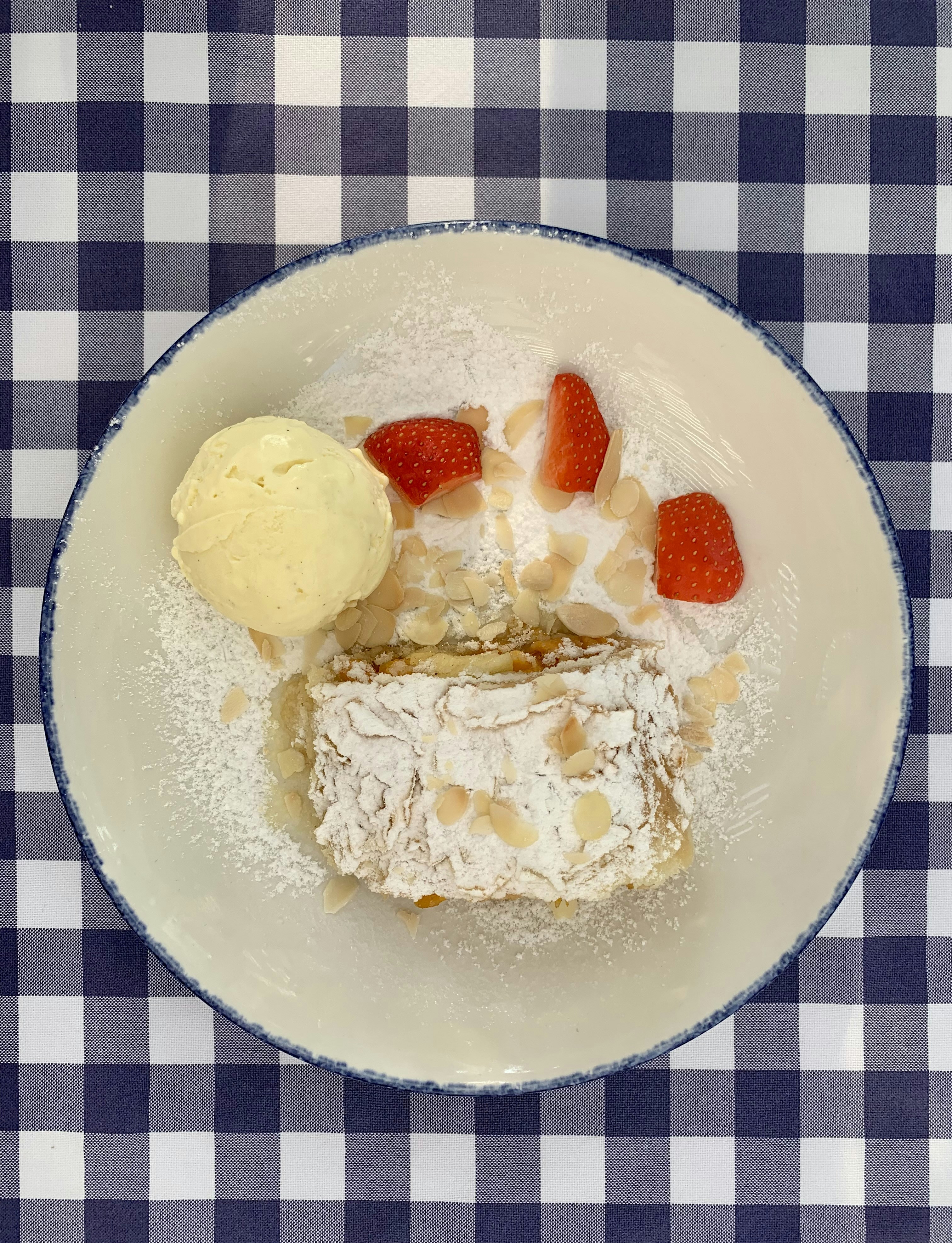 a white plate topped with a desert and a scoop of ice cream