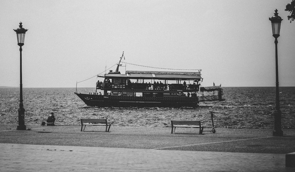a black and white photo of a boat on the water