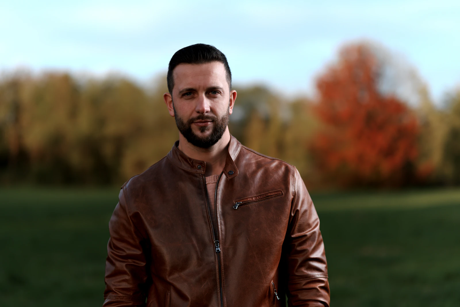 Man in brown leather jacket outdoors