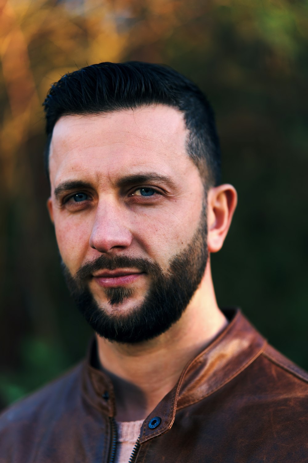 a close up of a person wearing a leather jacket